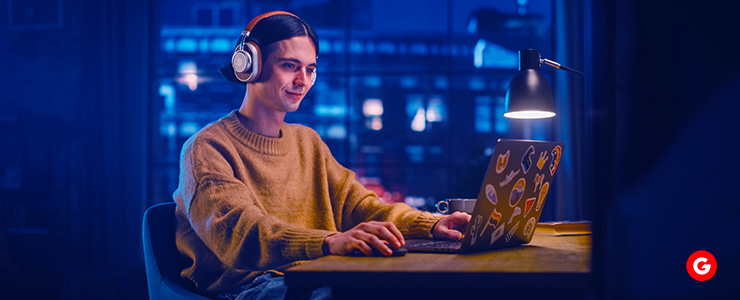 A trader intently focused in front of his laptop, engrossed in the world of trading.