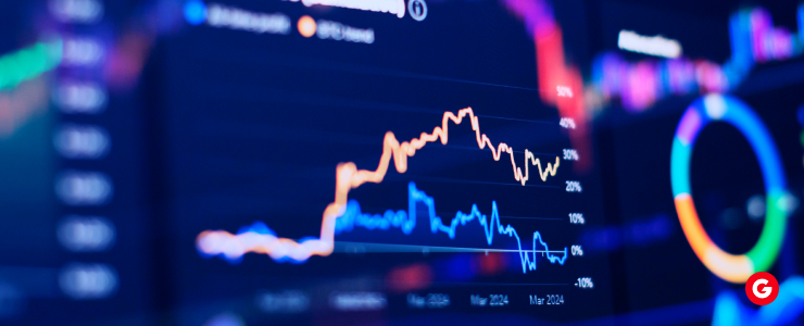 Close-up of a screen displaying a stock market graph with fluctuating lines and data points.