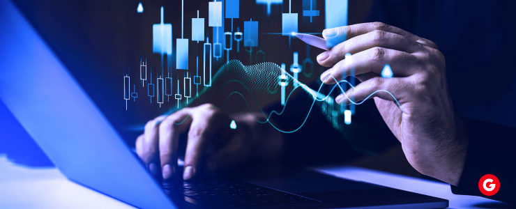 A person using a laptop displaying a graph comparing MT4 and MT5 trading platforms.
