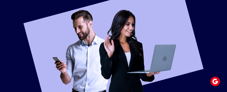 A man and woman hold up their laptops, engaged in forex CFD trading, smiling and sharing their success.